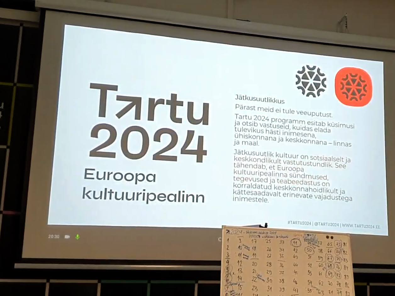 On the project screen on the wall, Tartu 2024 logo is displayed as well as the Estonian language description of one of Tartu 2024's core values - sustainability.